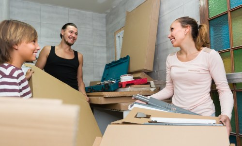 Storage team sorting recyclable cardboard and packaging materials
