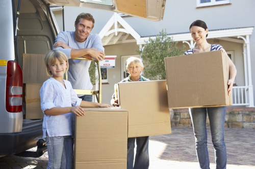 Prepared living room for house removals in Richmond upon Thames with labelled moving boxes