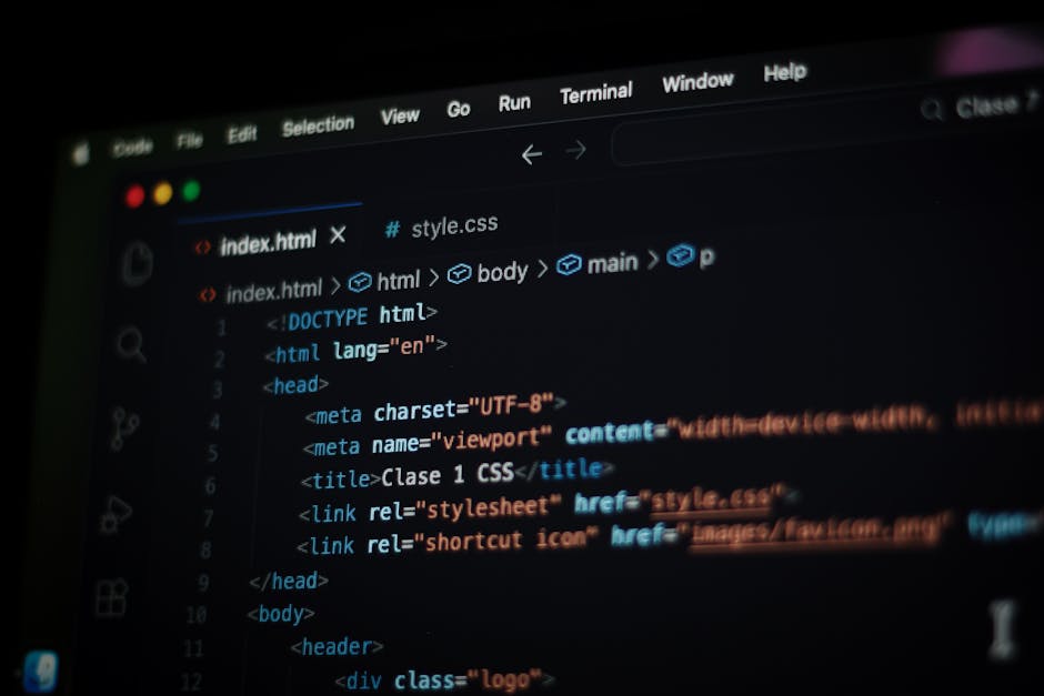 Photograph of a computer screen displaying a close-up view of colorful lines of programming code, including keywords, functions, and variables in various colors such as red, green, blue, and yellow. T